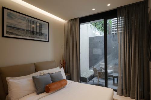 a bedroom with a bed and a view of a balcony at Edgar Allan Poe 227 By Ömora in Mexico City