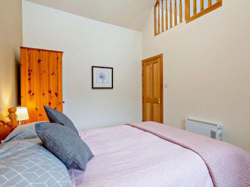 ein Schlafzimmer mit einem großen Bett mit Kissen in der Unterkunft 1 Bed in Beauly 82778 in Beauly