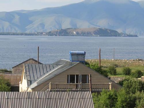 a house with a blue object on top of it at Guest House Chkalovka Garden in Sevan