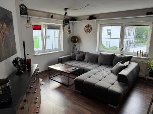 a living room with a couch and a table at Usedom Suite Zeitlos - 100 Meter zum Strand in Ostseebad Koserow