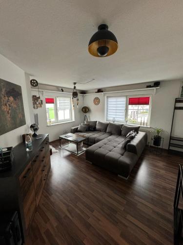 a living room with a couch and a table at Usedom Suite Zeitlos - 100 Meter zum Strand in Ostseebad Koserow