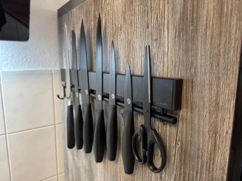 a bunch of knives hanging on a wall at Usedom Suite Zeitlos - 100 Meter zum Strand in Ostseebad Koserow