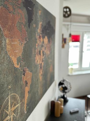 a map of the world hanging on a wall at Usedom Suite Zeitlos - 100 Meter zum Strand in Ostseebad Koserow