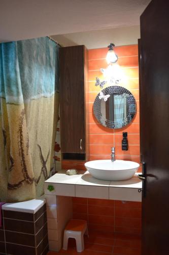 a bathroom with a sink and a mirror at Oikia Samiotaki Emmanouil in Sarti