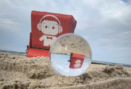 a glass ball in the sand on a beach at Usedom Suite Zeitlos - 100 Meter zum Strand in Ostseebad Koserow