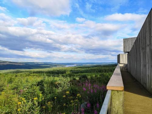 a view from the deck of a house with flowers at 3 Bed in Kielder 78280 in Falstone
