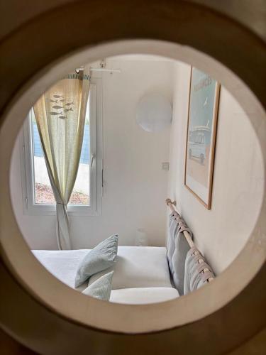 a view of a bedroom with a couch and a window at Gîte L ' Escale 300 m à pied des plages in Plouarzel