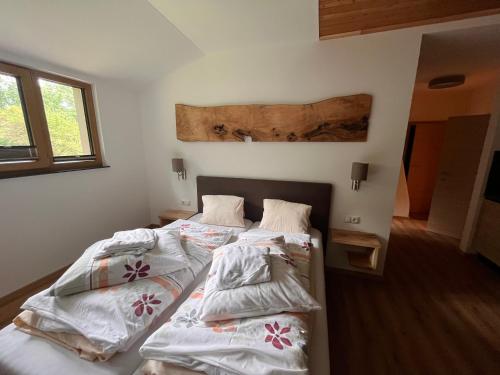 two beds in a room with white sheets at Familienbauernhof Glawischnig-Hofer in Gmünd in Kärnten