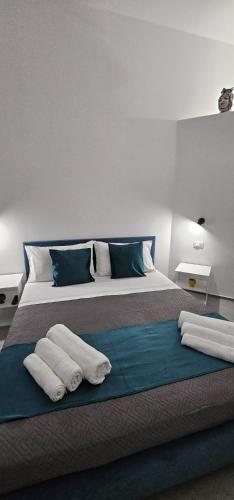 a bedroom with a large bed with towels on it at Apa Sicula in Avola