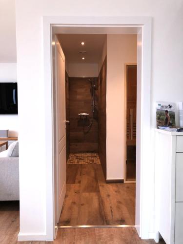 a hallway leading to a bathroom with a shower at Stora älg -Ferienhaus am Älgsjön in Arvika