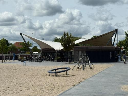 a pavilion with a bench in front of a building at Apartment with Wifi, close to city center, Beach and forrest in Aabenraa