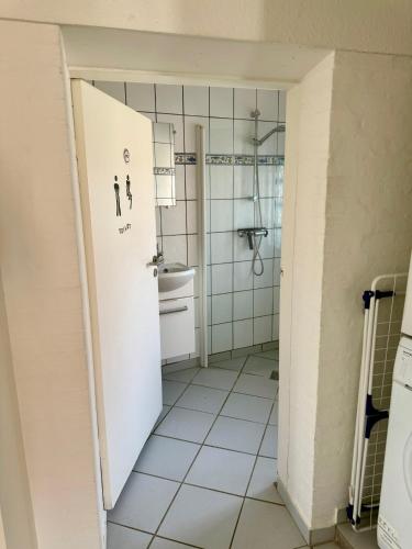 a small bathroom with a toilet and a sink at Apartment with Wifi, close to city center, Beach and forrest in Aabenraa