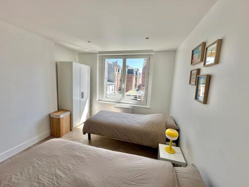 a bedroom with two beds and a window at Apartment in city center - Garage - Beach 200 m in Berck-sur-Mer