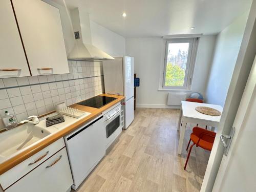 a white kitchen with a sink and a counter at Apartment in city center - Garage - Beach 200 m in Berck-sur-Mer
