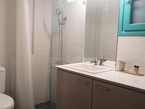 a bathroom with a sink and a shower at The Iconpainter Zaga Villa in Kómboi