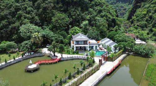 an aerial view of a house in the middle of a river at Tam Coc Ecolodge in Vũ Lâm