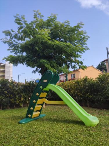a green and yellow slide in a park at Wilma House in Venice