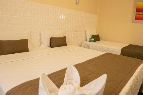 Ένα ή περισσότερα κρεβάτια σε δωμάτιο στο Garda Hotel
