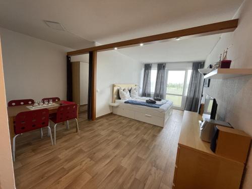 a bedroom with a bed and a desk and a table at #Backbord# direkt an der Ostsee in Schönberg