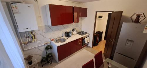 a small kitchen with a sink and a refrigerator at Apartament Tiana in Mamaia Nord