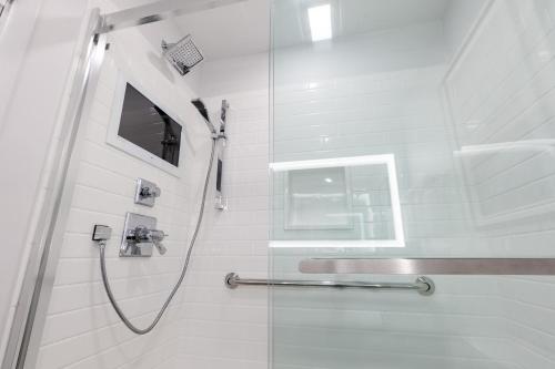 a bathroom with a shower with a glass door at Aspinquid Resort in Ogunquit