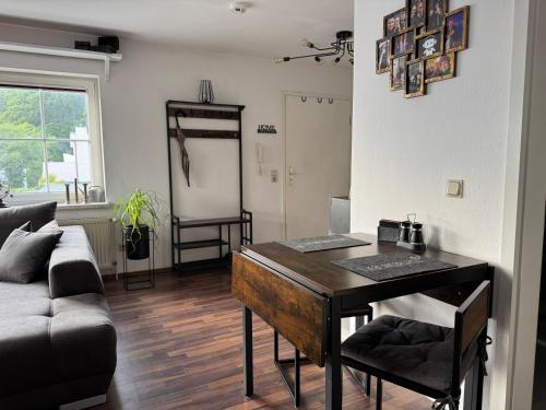 a living room with a table and a couch at Usedom Suite Zeitlos - 100 Meter zum Strand in Ostseebad Koserow