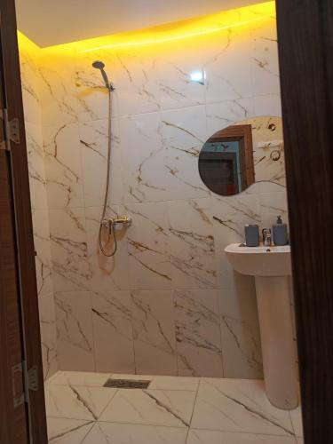 a bathroom with a marble shower and a sink at El jadida in El Jadida