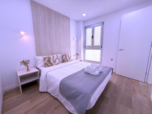 a white bedroom with a large bed and a window at San Francisco Central Suites Penthouse in Santa Cruz de Tenerife