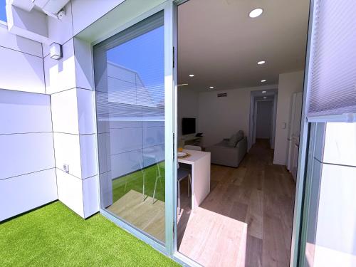 a room with a sliding glass door with a living room at San Francisco Central Suites Penthouse in Santa Cruz de Tenerife