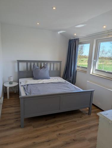 a bedroom with a bed and a window at Emden - Ferienwohnung mit Kanal-Blick in Emden