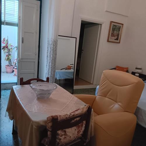 a living room with a table and a chair at Casa Nashi in Ugento