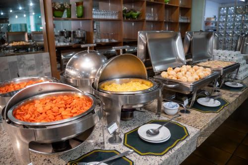 a buffet line with many different types of food at Hotel Nacional Inn Poços de Caldas - Lazer completo e Gastronomia no Centro in Poços de Caldas
