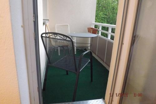 a small table and chair on a balcony at GME Easyflex Home-1 in Berlin