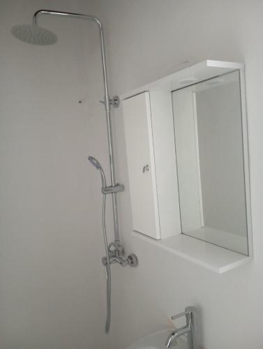 a bathroom with a mirror and a sink at Ateni Beachfront in Aténi