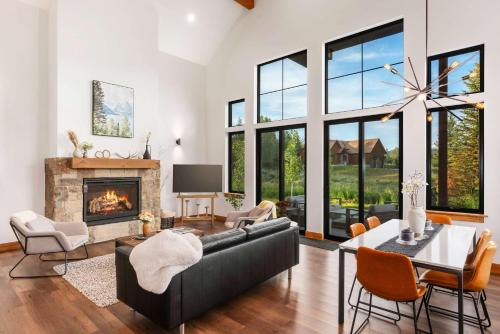 a living room with a couch and a fireplace at Upscale Ski Chalet - Wildlife AC Hot Tub in Driggs
