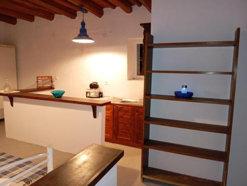 a kitchen with a counter and a ladder in a room at Ateni Beachfront in Aténi