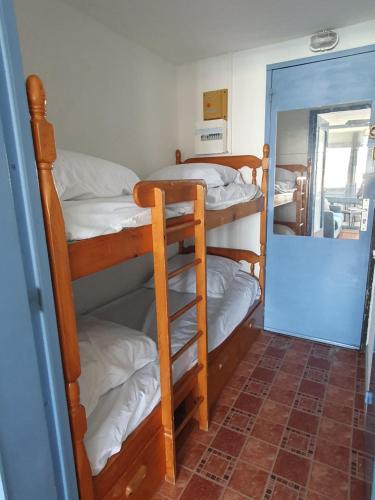 a room with three bunk beds and a mirror at Studio vue Mer Ile des Pêcheurs in Cap d'Agde