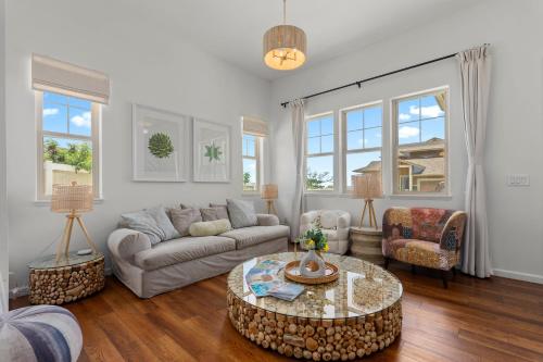 a living room with a couch and a table at Makaha Villa by AvantStay Mountain Ocean Views in Waianae