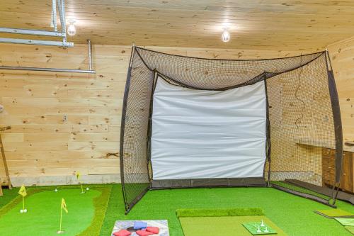a large net in a room with a goal at Less Than 1 Mi to ATV Trails Cadillac Golf Retreat! in Cadillac