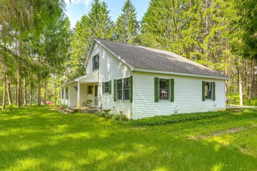 a white house in the middle of a yard at Less Than 1 Mi to ATV Trails Cadillac Golf Retreat! in Cadillac