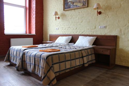 a bedroom with a bed with two towels on it at RA na Rybinskoy 7 in Saint Petersburg