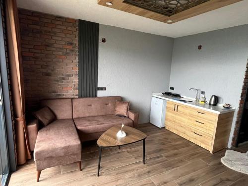 a living room with a couch and a table at Seyr-i Keyf Suit Bungalov in Rize
