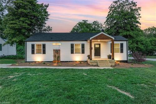 a small white house with a lawn at 3BR Elam Retreat • Work & Rest in Sunset Hills