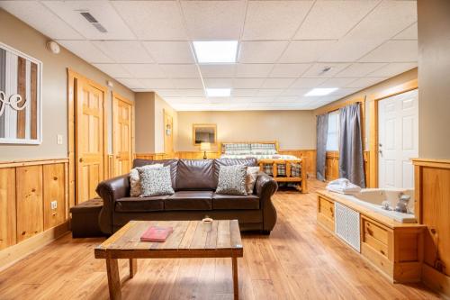 a living room with a couch and a table at Anglers Bend By Avada Properties in Pigeon Forge