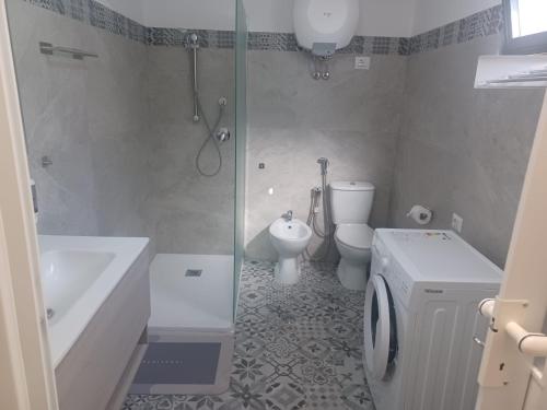 a bathroom with a shower and a toilet and a sink at Casa Francy in Alghero