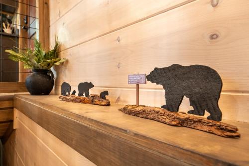 a shelf with two statues of elephants and a sign at Away From It All By Avada Properties in Sevierville
