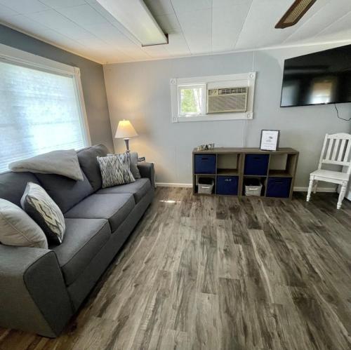 a living room with a couch and a table at Cozy Cottage on Indian Lake with AC in Manistique