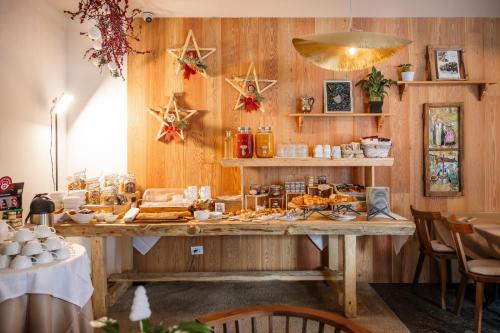 a room with a table with food on it at Bach Boutique Hotel in Sappada
