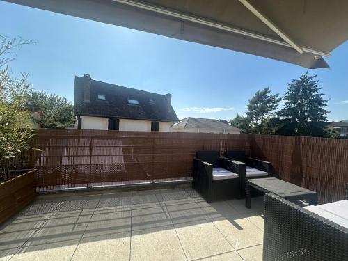 a patio with a fence and benches and a building at Nice and cosy appartement Annecy in Annecy