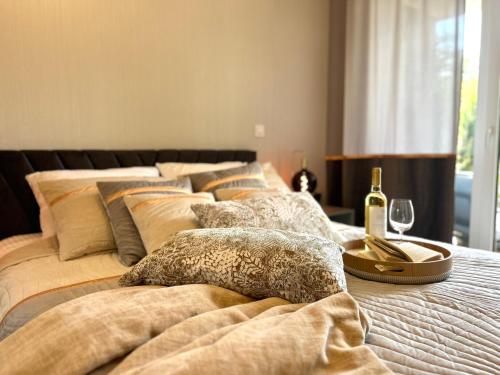 a row of beds with pillows and a tray of wine glasses at Augustów apartament nad jeziorem in Augustów